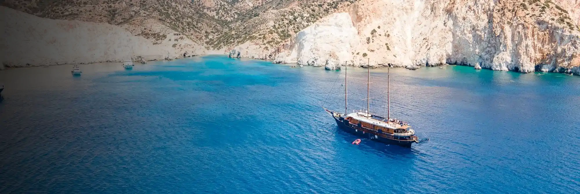 A traditional gulet anchored in a quiet cove on a small ship cruise